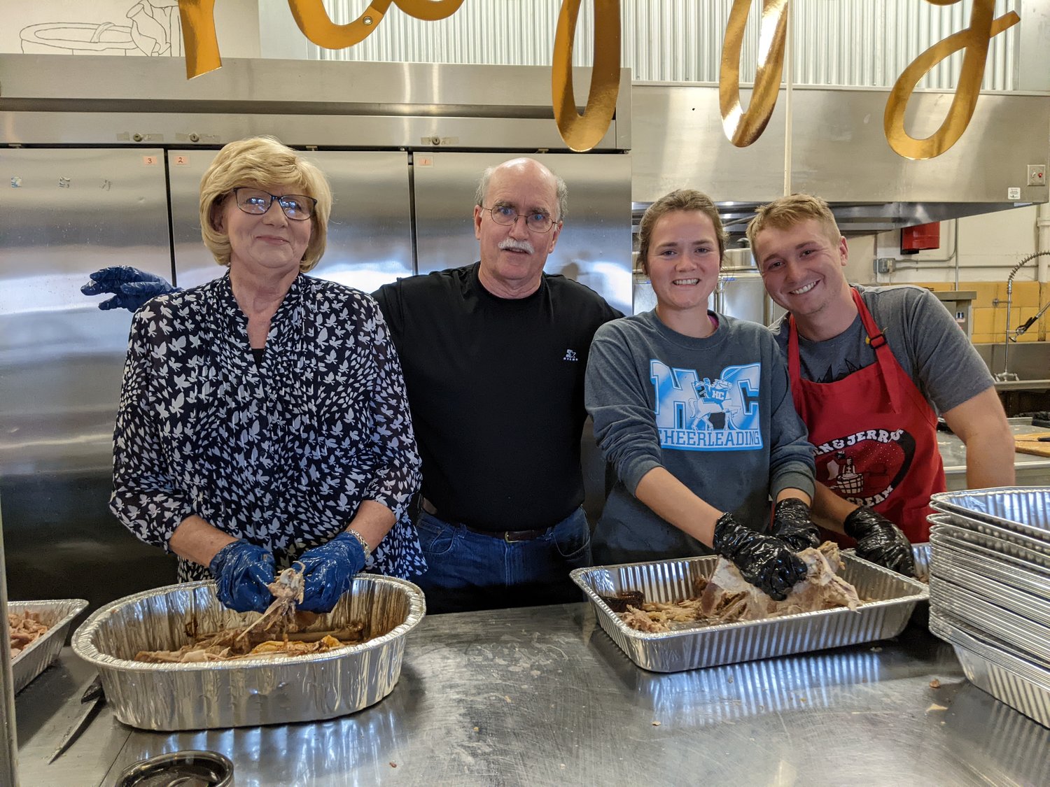 From left, Elaine Meller, Mike Skain, Anna Kolb and Sam Giftos debone cooked turkeys Sunday, Nov. 20, 2022, at Immaculate Conception Catholic Church in Jefferson City. After removing the bones, the volunteers stored the turkey meat in pans with gravy to prevent drying before Thursday's Thanksgiving meal offered free to the public.